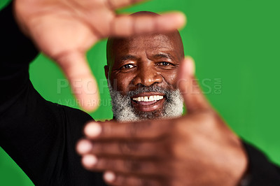 Buy stock photo Studio shot of a senior man forming a finger frame in front of his face