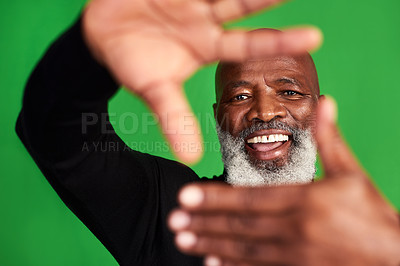 Buy stock photo Studio shot of a senior man forming a finger frame in front of his face