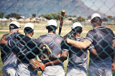 Buy stock photo Rearview shot of a group of young men standing together in solidarity at a baseball game