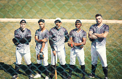 Buy stock photo Portrait of a group of confident young men playing a game of baseball