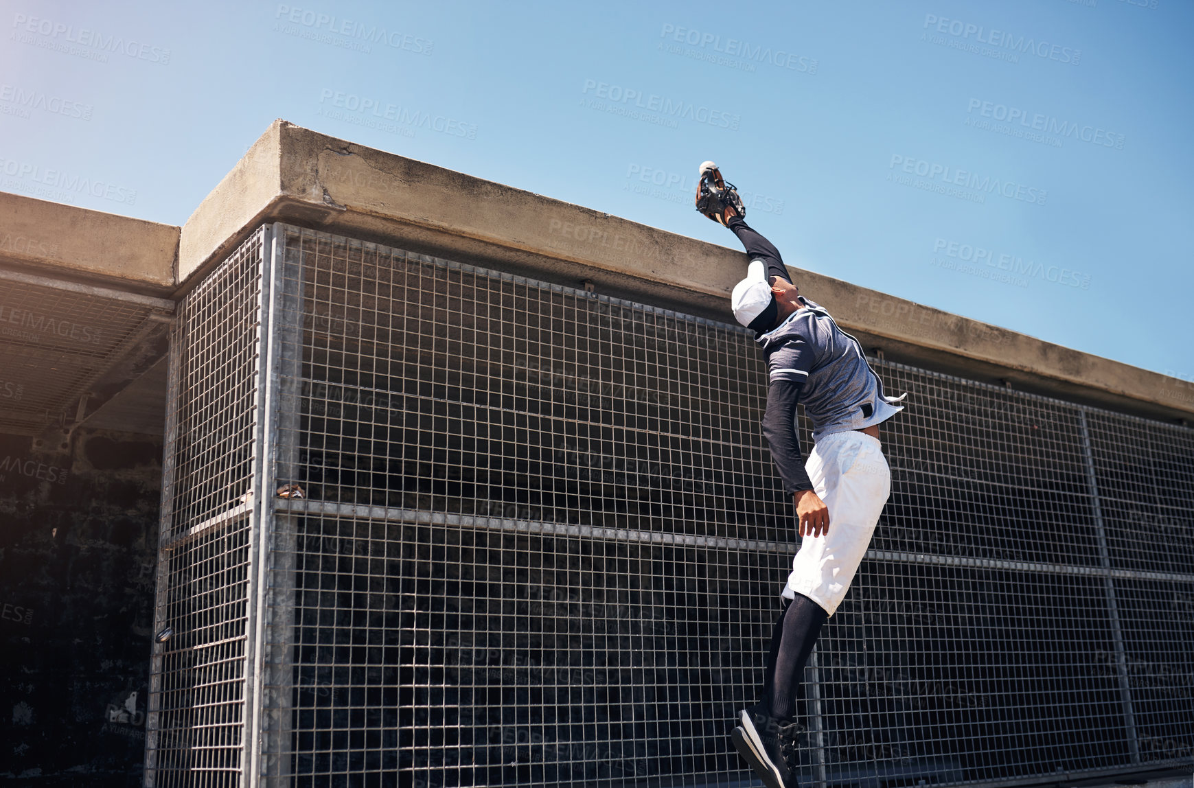 Buy stock photo Shot of a young man catching a ball at a baseball match