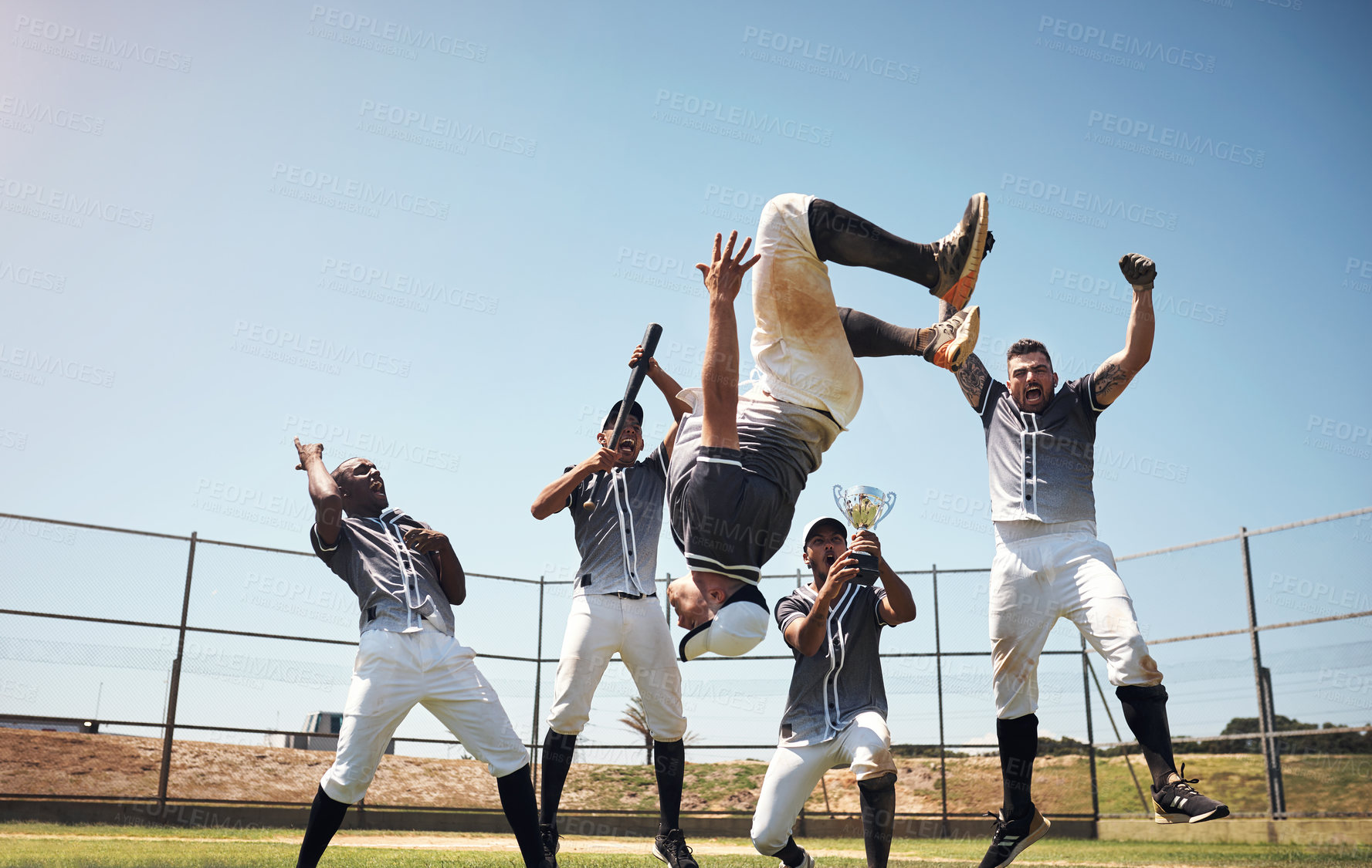 Buy stock photo Shot of a group of young baseball players celebrating after winning a game
