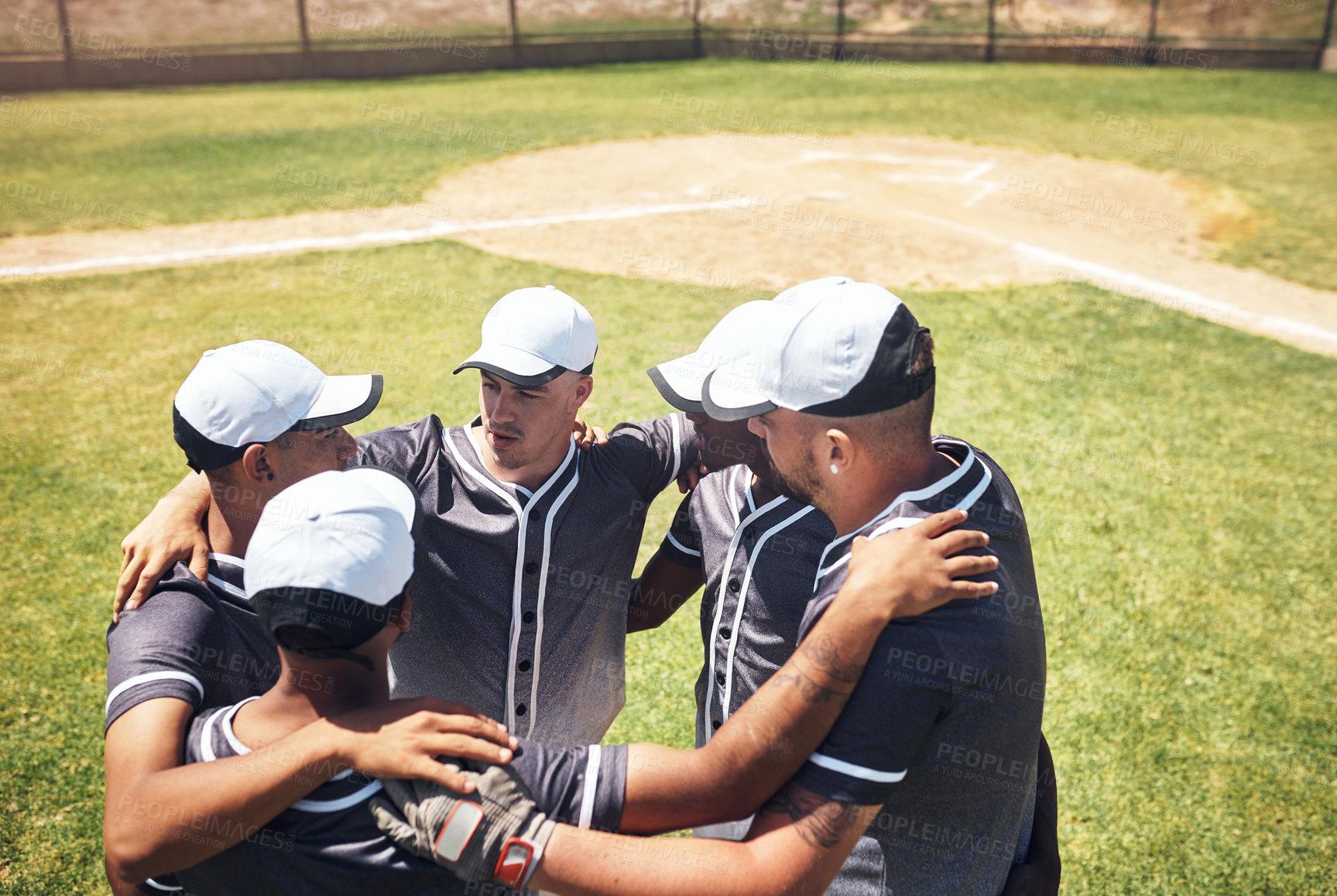 Buy stock photo Shot of a group of young men huddled together at a baseball game