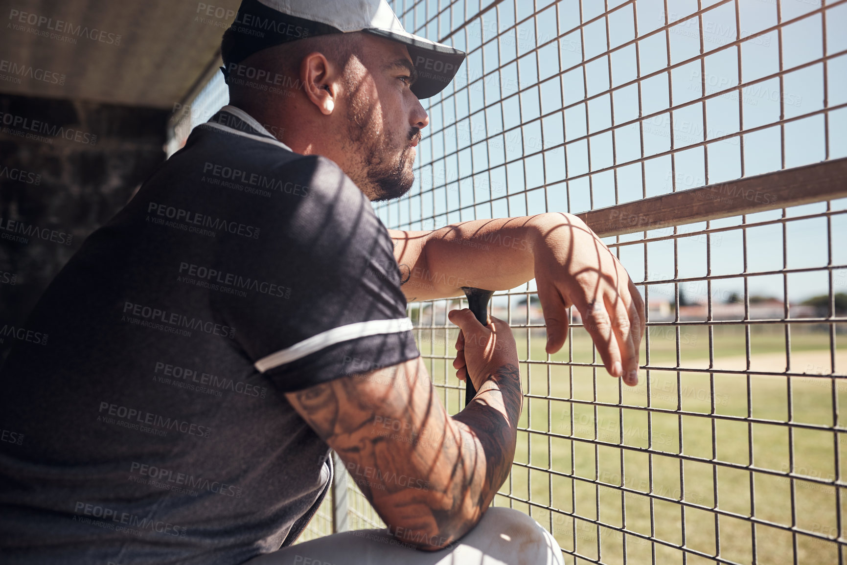 Buy stock photo Baseball, game and training with man in dugout, watching team sports outdoor for competition or fitness. Club, exercise and health with player at stadium or venue for challenge, match or performance