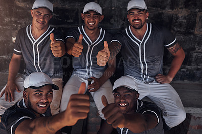 Buy stock photo Shot of a group of young baseball players sitting in the dugout and showing thumbs up