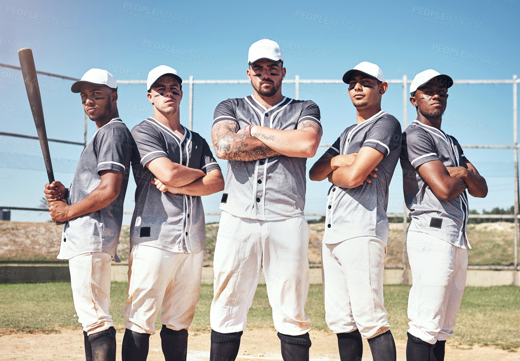 Buy stock photo Portrait of a group of confident young men playing a game of baseball