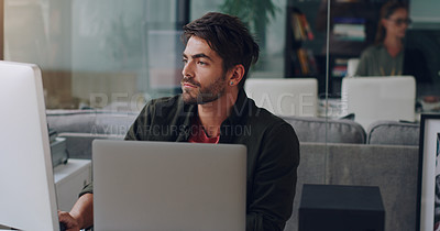 Buy stock photo Cropped shot of a handsome young businessman working on his computer in the office