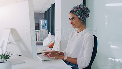 Buy stock photo Cropped shot of an attractive young businesswoman working on her computer in the office