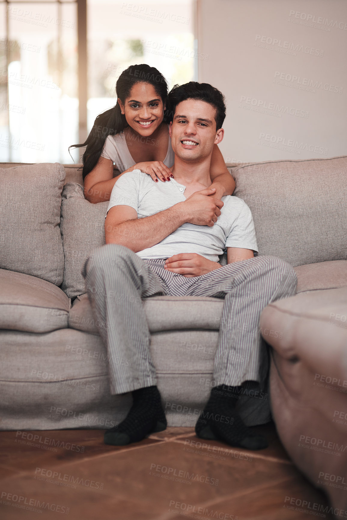 Buy stock photo Full length portrait of an affectionate young couple in their living room at home