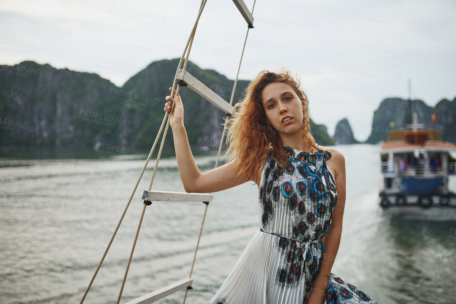Buy stock photo Shot of a young woman enjoying a boat ride in Vietnam