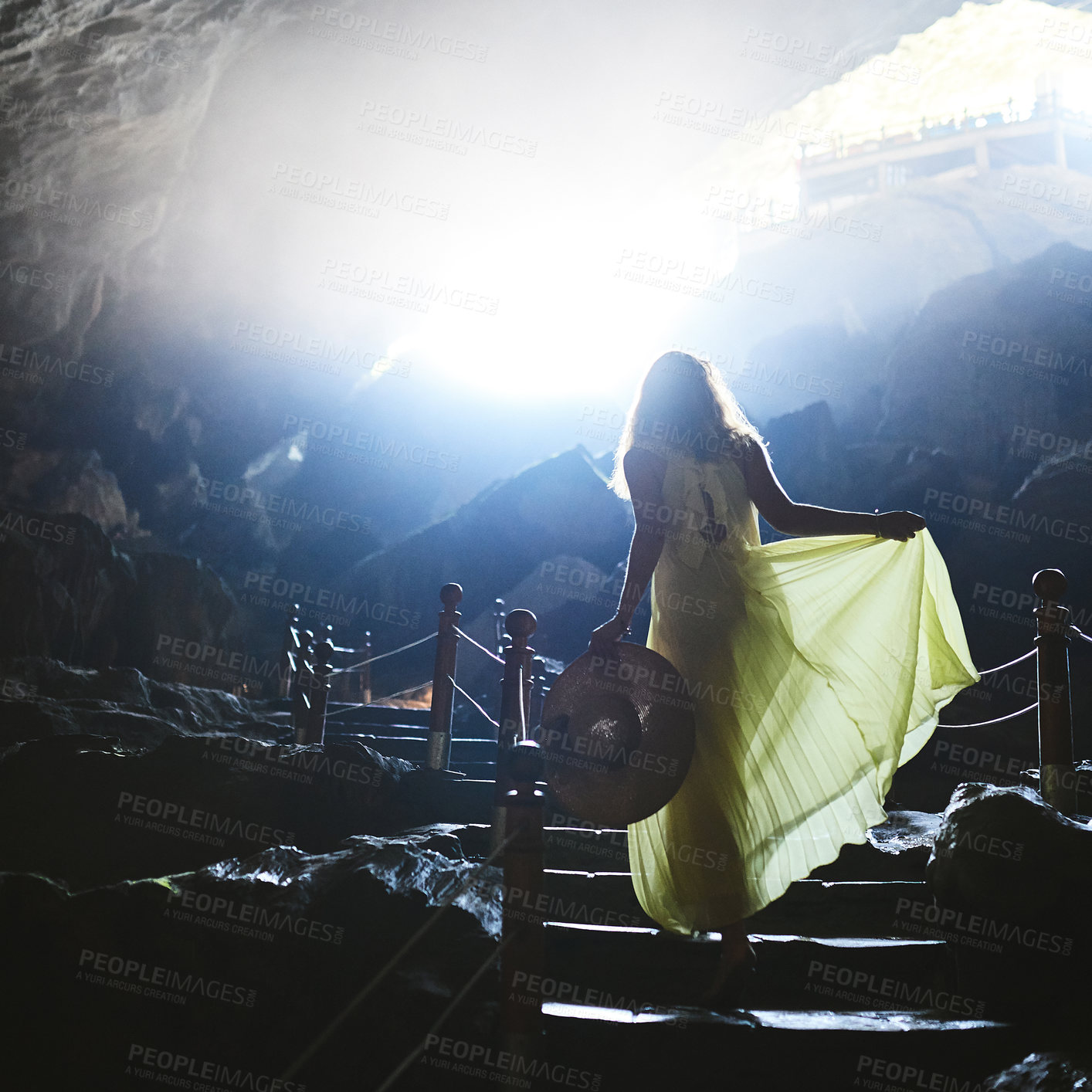 Buy stock photo Shot of a young woman walking up steps in a Vietnamese cave