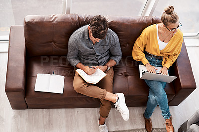 Buy stock photo High angle shot of two designers sitting on a couch in an office