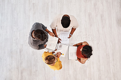 Buy stock photo High angle shot of a group of young designers having a discussion in an office