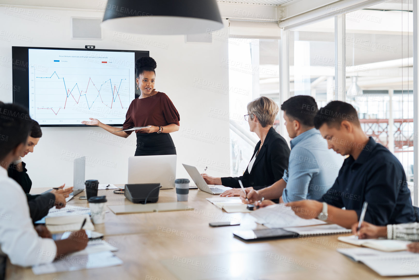 Buy stock photo Shot of a group of businesspeople having a meeting in a modern office