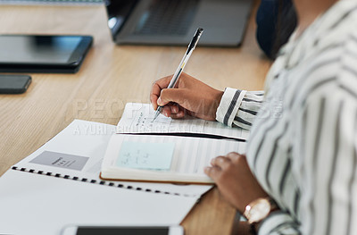 Buy stock photo Cropped shot of a businesswoman writing notes during a meeting in a modern office
