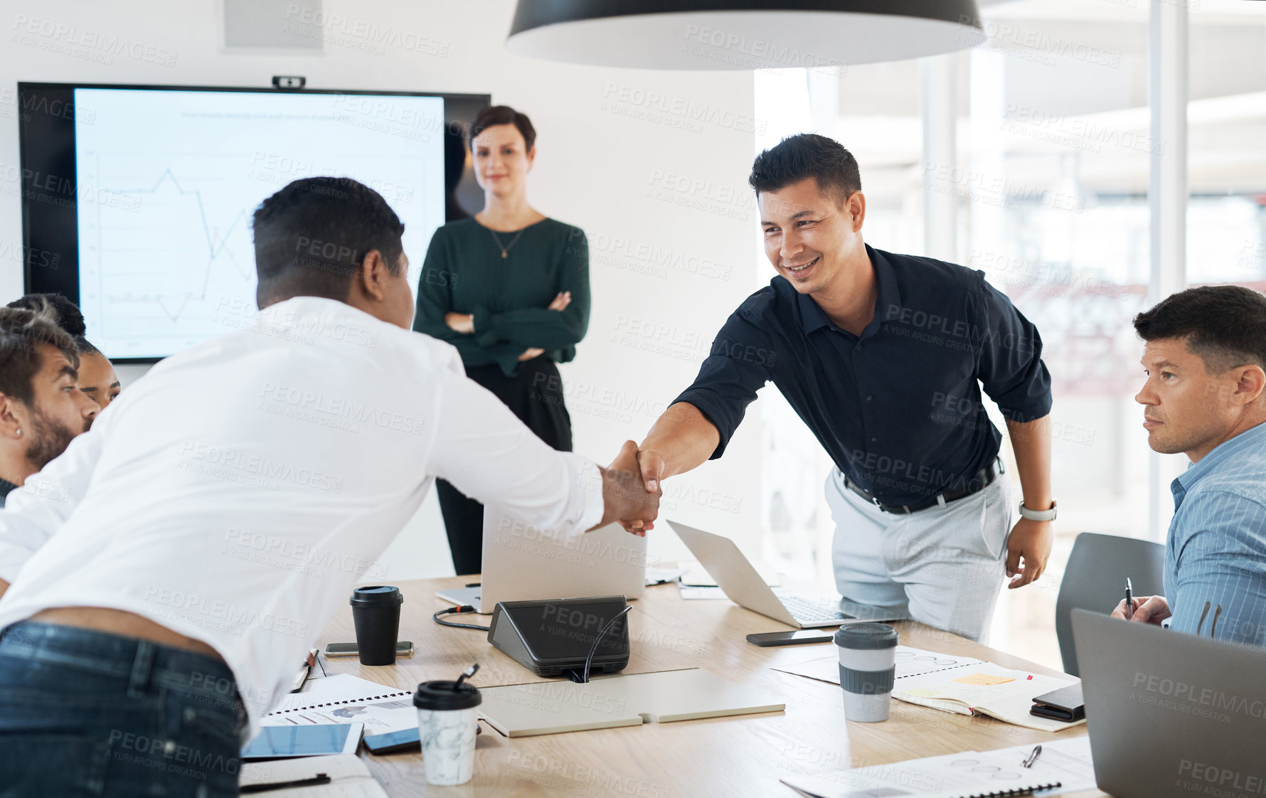 Buy stock photo Shot of businessmen shaking hands during a meeting in a modern office