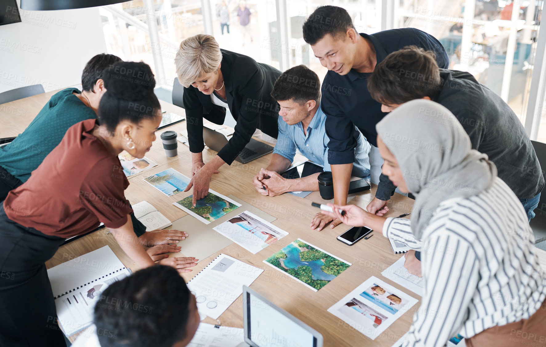 Buy stock photo Digital marketing, team or planning campaign in office to promote travel agency website or social media page. Creative business, diversity or people in boardroom with pictures for brainstorming ideas