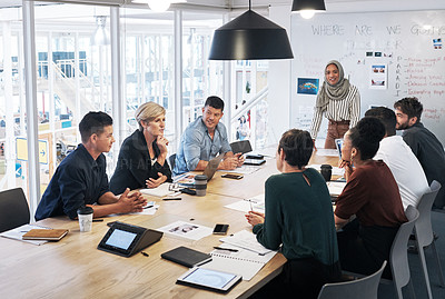 Buy stock photo Shot of a group of businesspeople having a meeting in a modern office