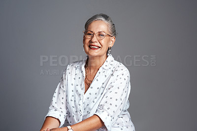 Buy stock photo Studio shot of a senior woman posing against a grey background