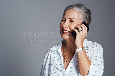 Buy stock photo Studio shot of a senior woman talking on her cellphone against a grey background