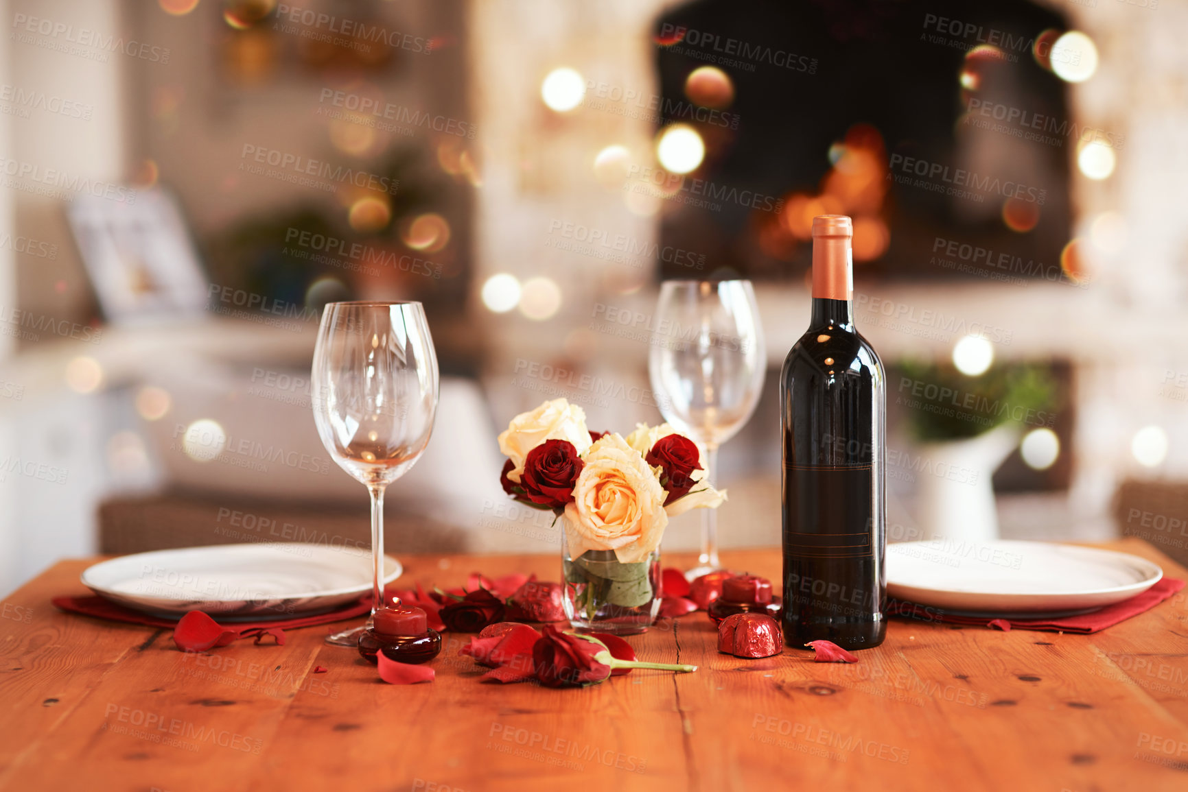 Buy stock photo Romantic, dinner table and setup for valentines day, fine dining or date at indoor night restaurant. Interior diner with wine glasses prepared with roses and champagne for evening couple reservation