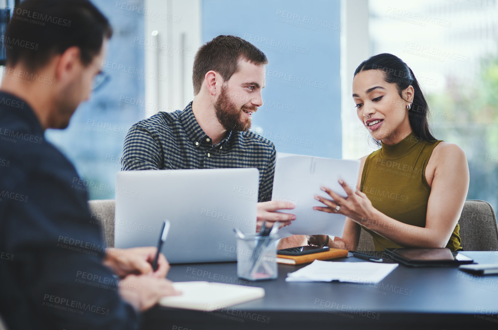 Buy stock photo Shot of a group of young designers having a discussion in an office