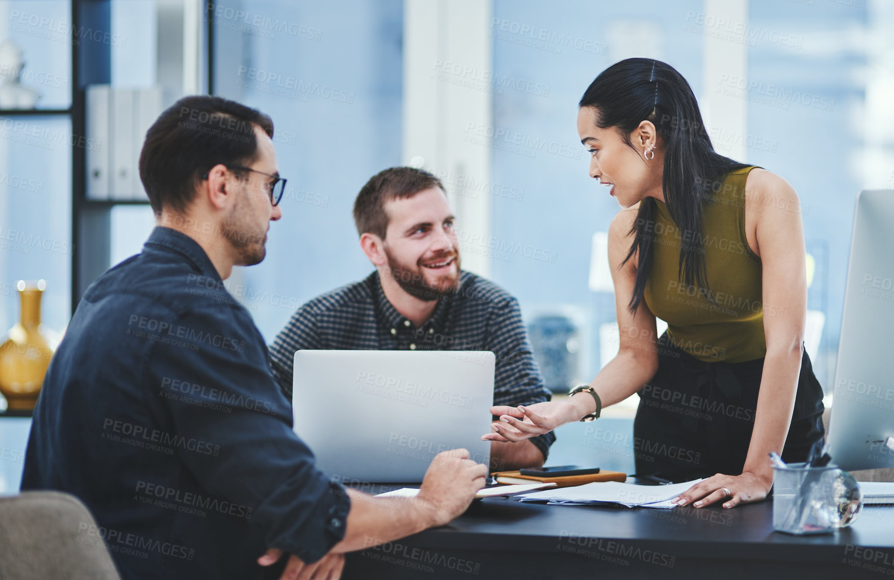 Buy stock photo Shot of a group of young designers having a discussion in an office