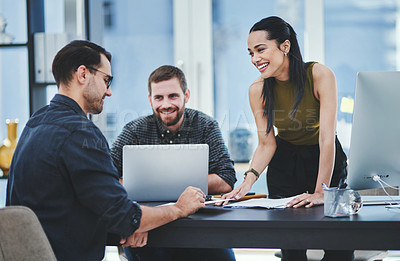 Buy stock photo Shot of a group of young designers having a discussion in an office