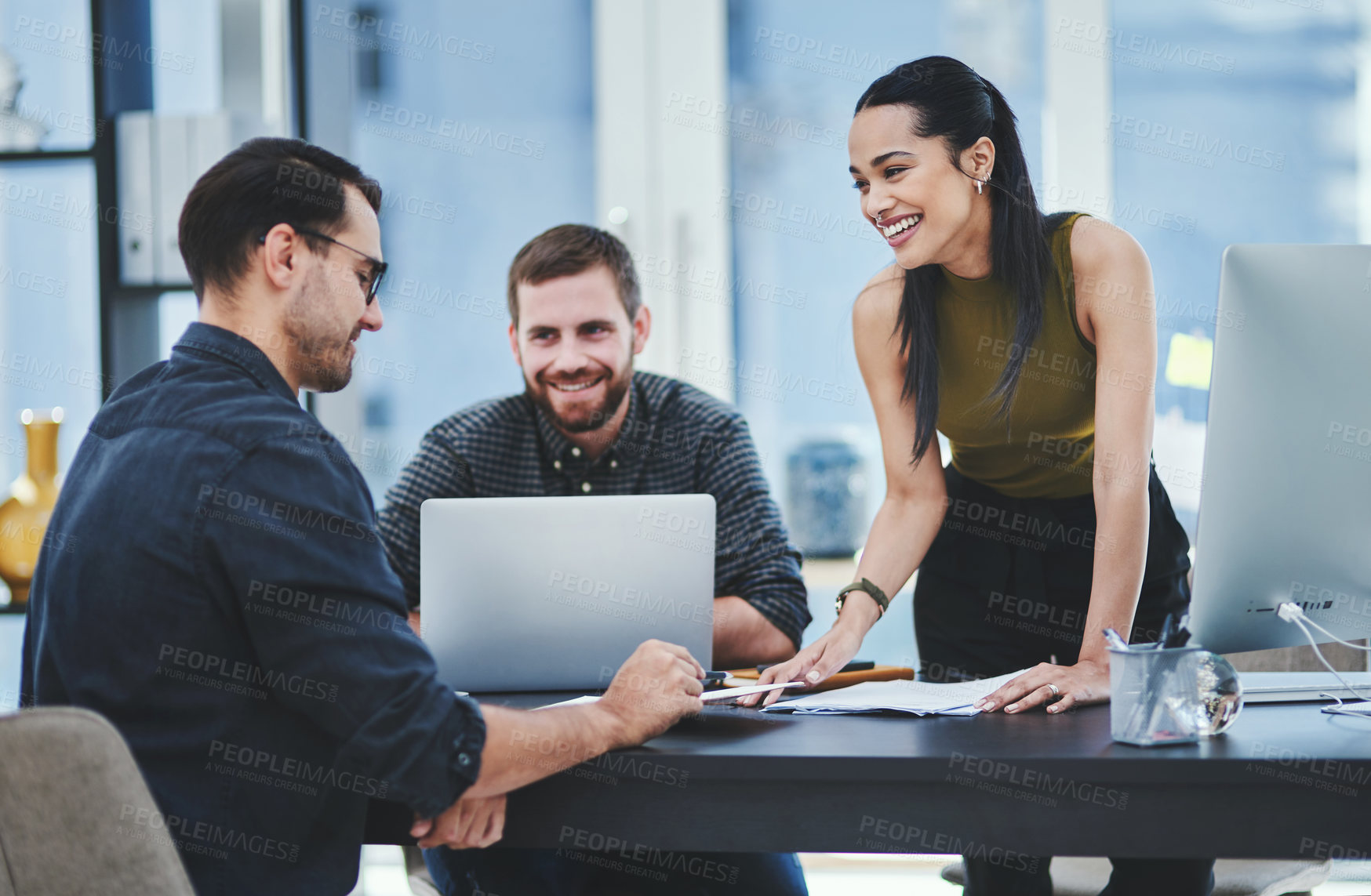 Buy stock photo Shot of a group of young designers having a discussion in an office