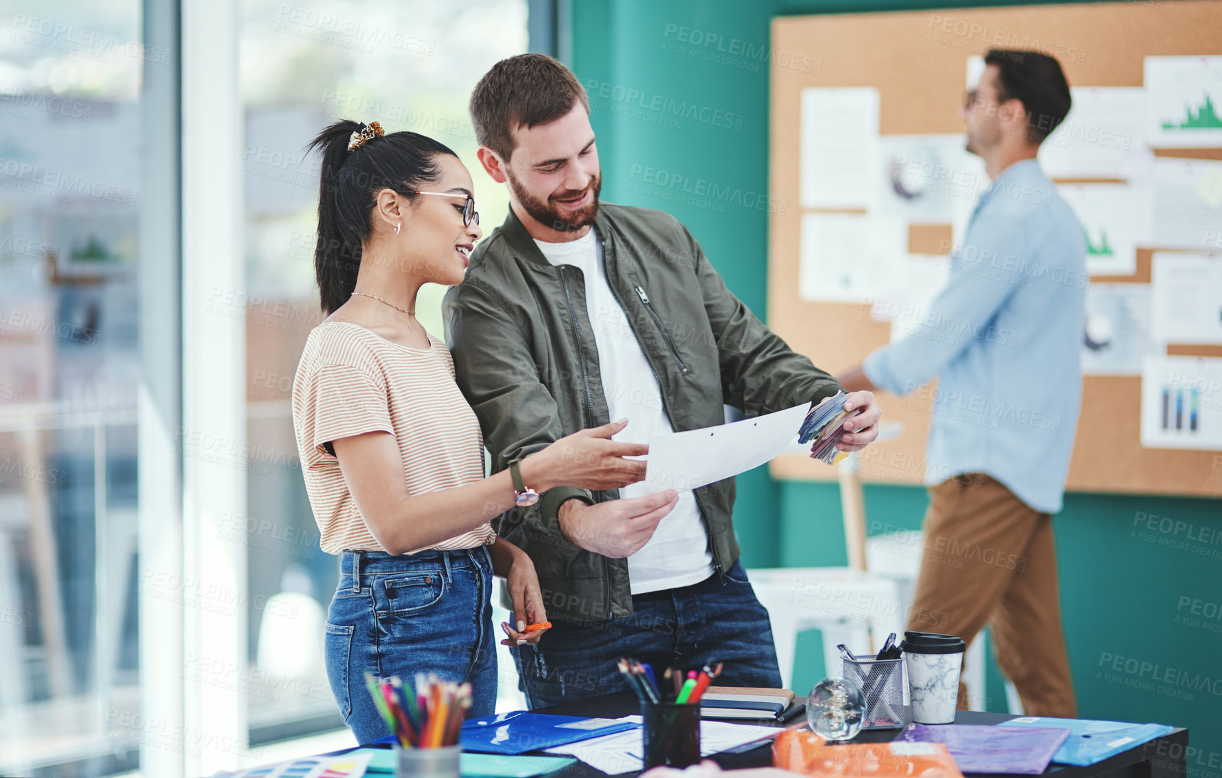 Buy stock photo Shot of two young designers having a discussion in an office