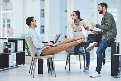 Buy stock photo Business people, meeting and collaboration in web design, brainstorming or strategy at office. Feet up, creative men and talking to designers for teamwork, planning or online startup with laptop