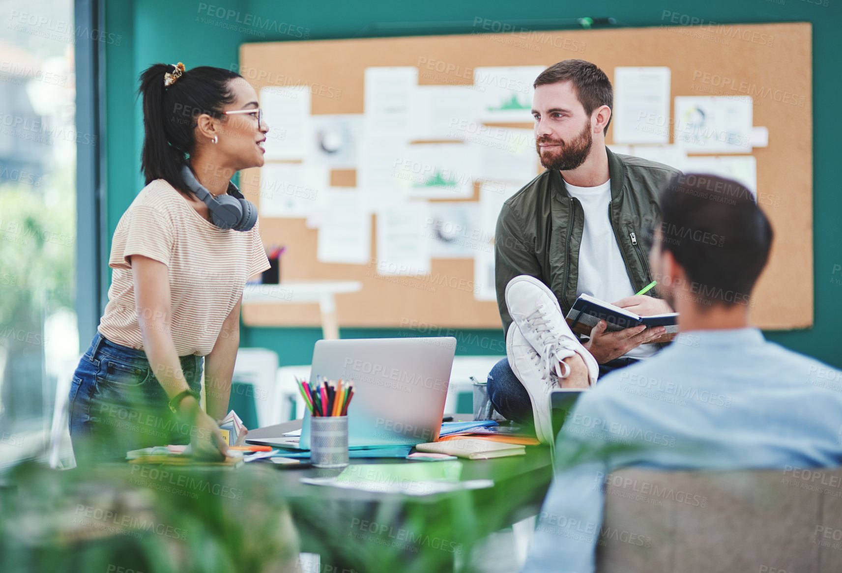 Buy stock photo Shot of a group of young designers having a discussion in an office