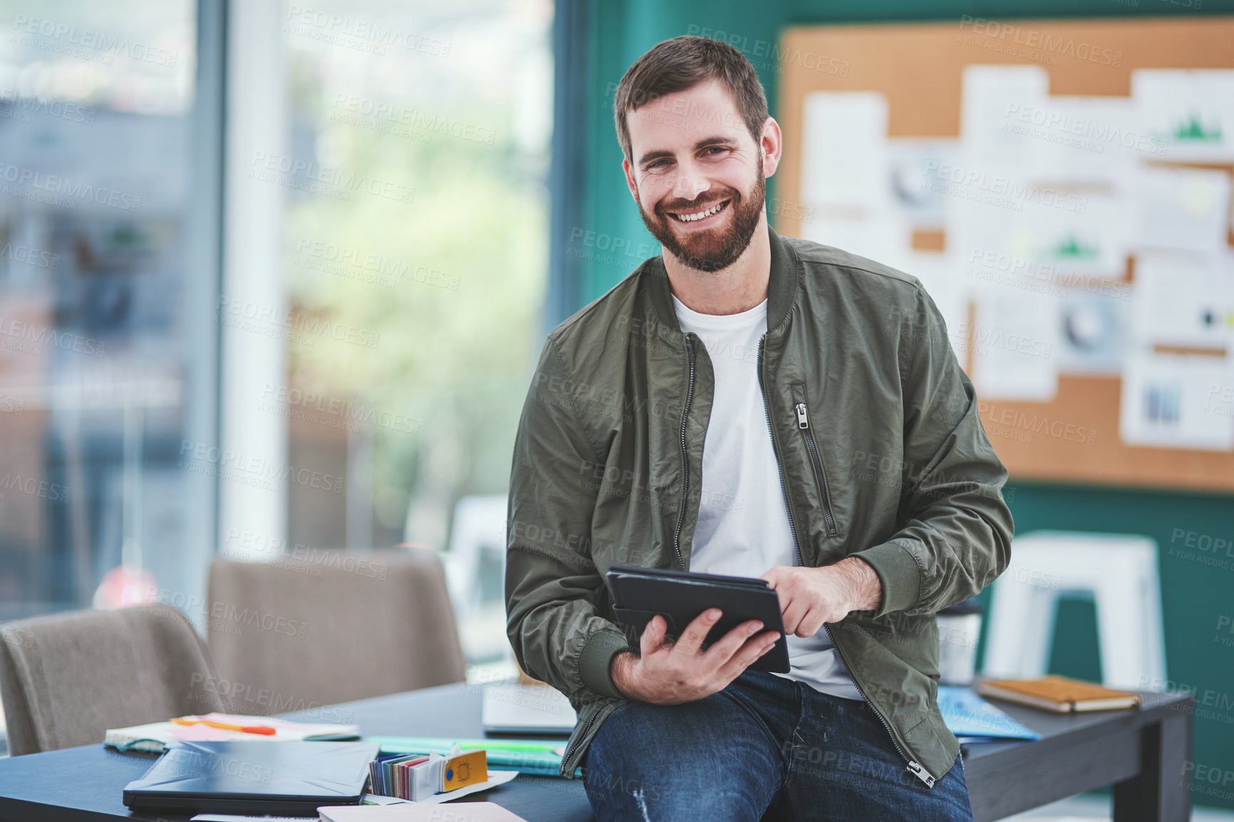 Buy stock photo Portrait of a young designer using a digital tablet in an office