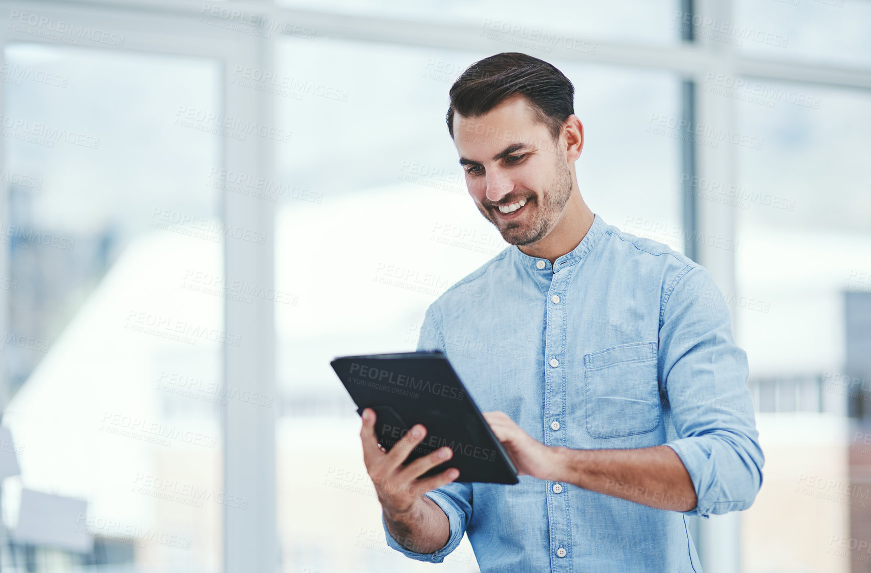 Buy stock photo Typing, business and man in office, tablet and internet with graphic designer. startup and smile. Entrepreneur, professional and consultant with creative agency, tech and research with digital app