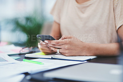 Buy stock photo Closeup shot of an unrecognisable designer using a cellphone in an office