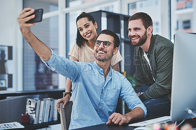 Buy stock photo Shot of a group of designers taking selfies together in an office
