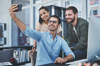 Buy stock photo Happy, business people and selfie with picture at office desk for memory or photography together. Young, group or employees with smile or team in joy for moment, capture or social media at workplace