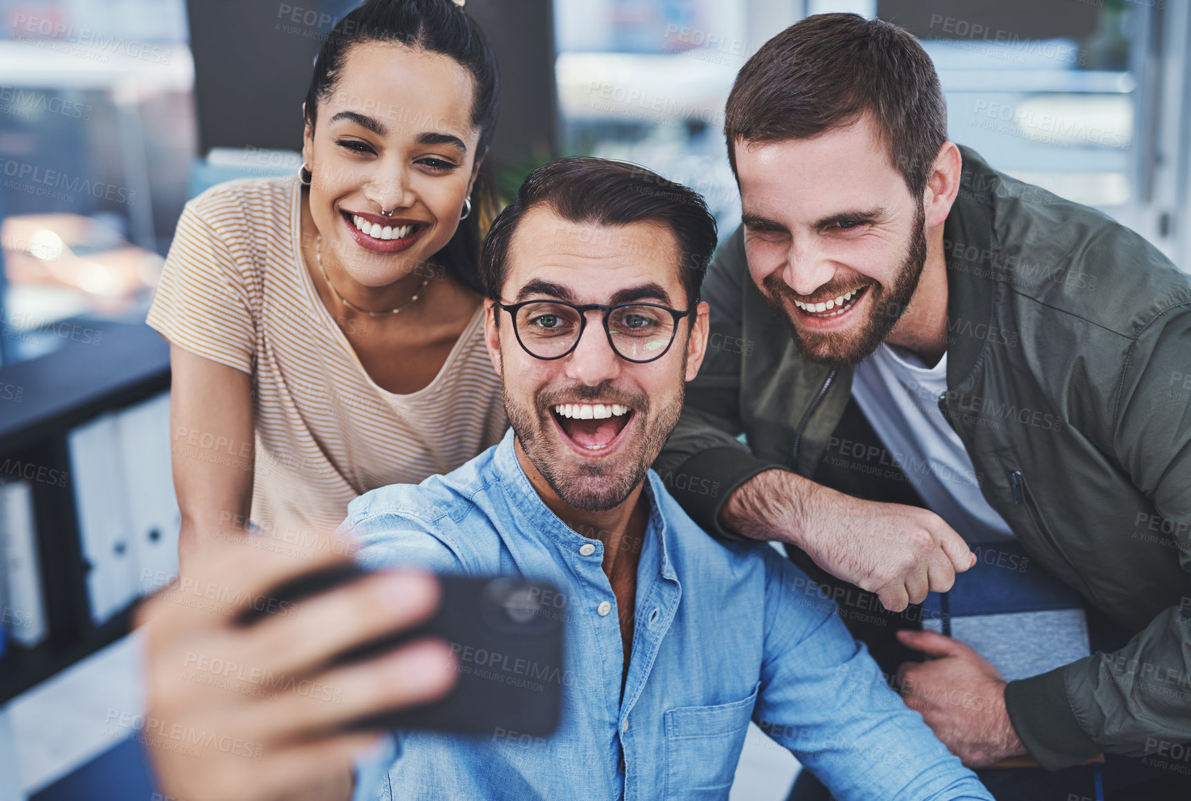 Buy stock photo Shot of a group of designers taking selfies together in an office