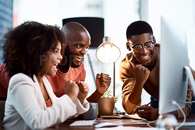 Buy stock photo Shot of a group of businesspeople looking at something on a computer screen in an office