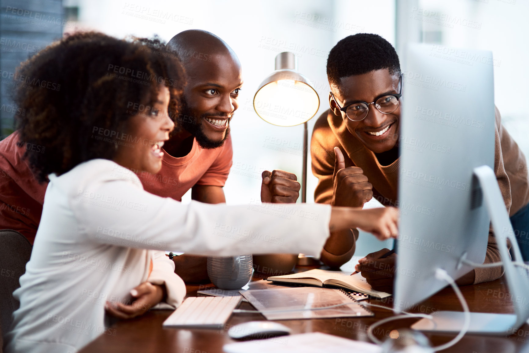 Buy stock photo Shot of a group of businesspeople looking at something on a computer screen in an office