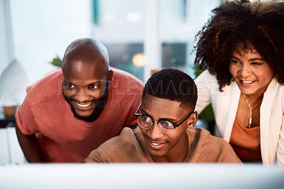 Buy stock photo Shot of a group of businesspeople looking at something on a computer screen in an office