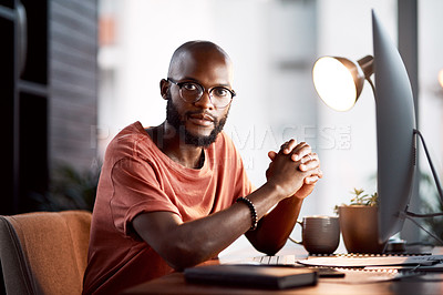 Buy stock photo Portrait of a handsome young businessman sitting at his desk