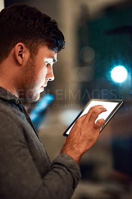 Buy stock photo Cropped shot of a businessman using a digital tablet while standing outside
