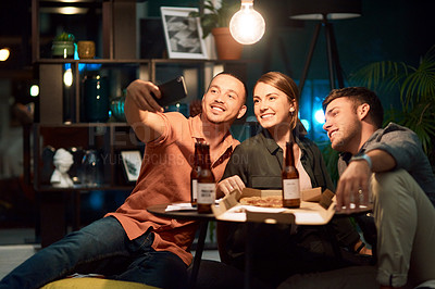 Buy stock photo Shot of a group of businesspeople taking a selfie while working late at the office