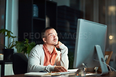 Buy stock photo Cropped shot of a business man using his computer while working late at the office
