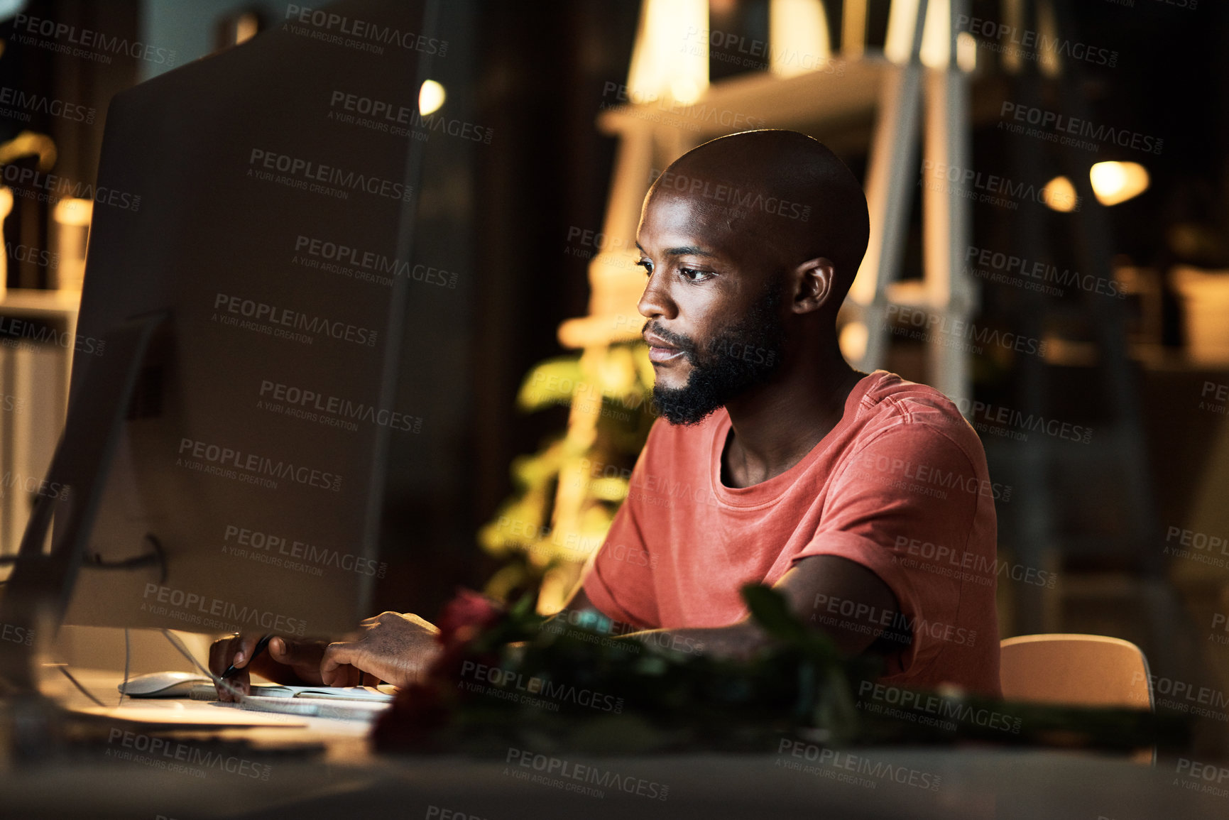 Buy stock photo Night, black man and serious in office, computer and video editing with software, planning and freelancer. Dark, entrepreneur and creative for content creation, person and business in social media