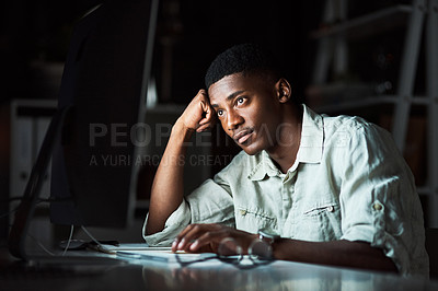 Buy stock photo Shot of a businessman looking tired while working late at the office