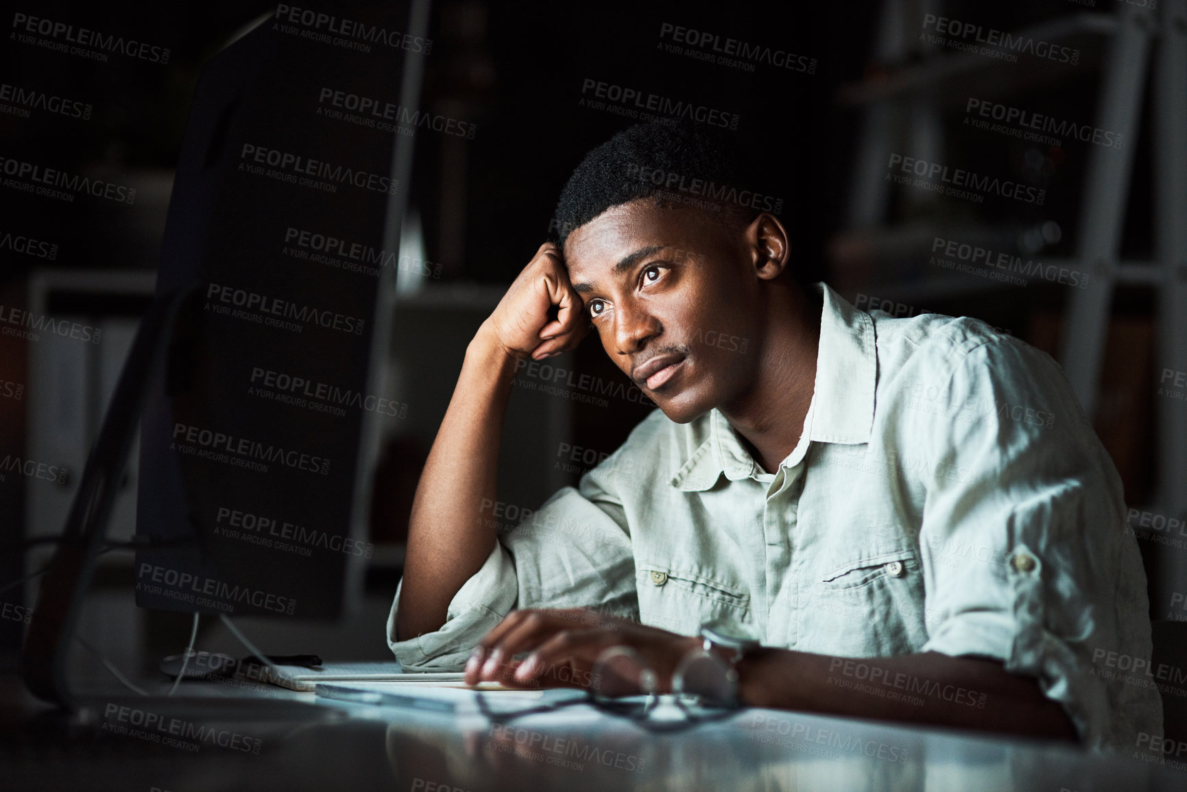 Buy stock photo Shot of a businessman looking tired while working late at the office