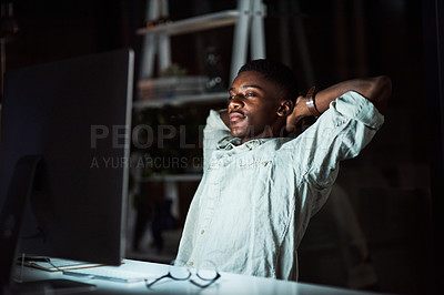 Buy stock photo Shot of a businessman looking relaxed while working late at the office