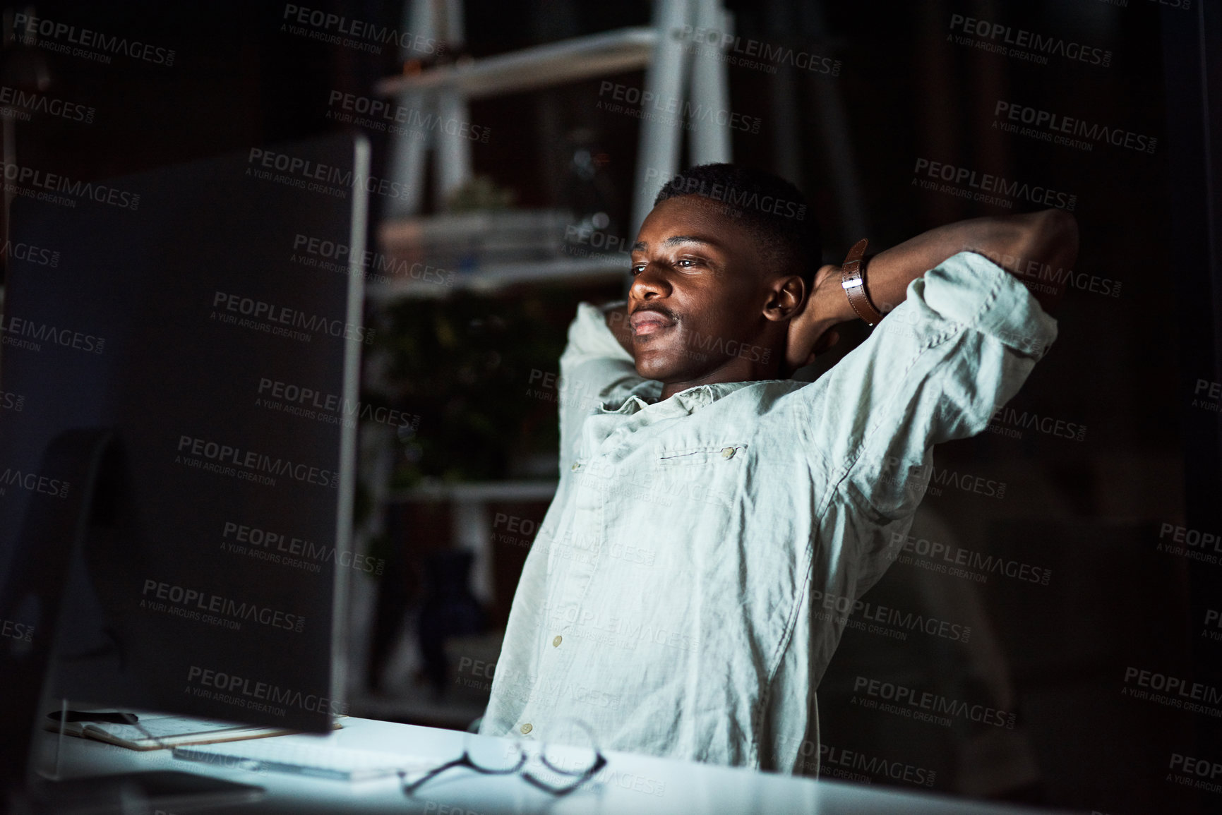 Buy stock photo Night, man and sleeping in office, tired  and video editing with software, overworked and computer. Dark, fatigue and overwhelmed by content creation, black person and exhausted, dreaming and burnout